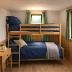 Bunk beds in shepherd's hut next to window for guests