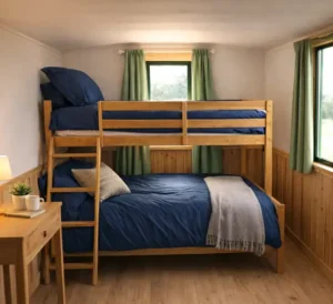 Bunk beds in shepherd's hut next to window for guests