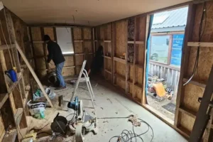 Shepherd’s hut under construction showing timber framing, insulation installation and internal build work