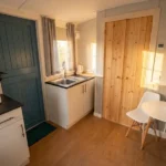 Small kitchen with chair and table in shepherd's hut