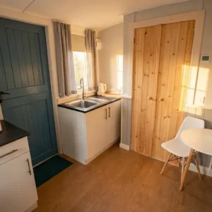Small kitchen with chair and table in shepherd's hut