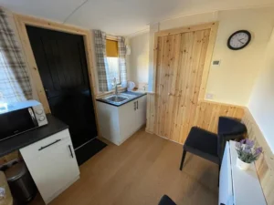 Shepherd’s hut kitchenette area with sink, worktop and seating space